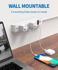 Heavy Duty Surge Protector Power Strip With 6 Outlet Slots And 6 Feet Extension Cord delivering 600 Joules Protection, wall-mounted with devices.