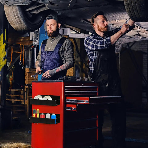 Mechanics using toolbox under car with six pack magnetic aerosol can holders with two sizes and four hooks attached to red cart.