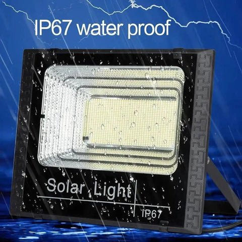 JUDYSSY 800W Solar Floodlight Outdoor Spotlight IP66 Waterproof with Remote Control on display with IP67 water proof label.