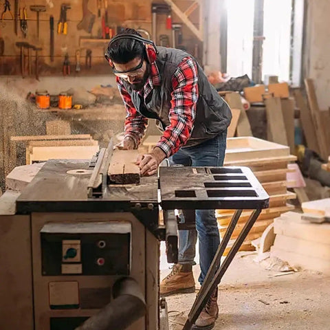 Woodworker using Pro Grade Aluminum Miter Track Jigs T Slot Guide for woodworking on table saw in workshop.