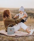 Mom with child outdoors, Grab And Go Insulated Breastmilk Cooler Bag Fits Four Nine Ounce Bottles Leakproof Travel Storage.