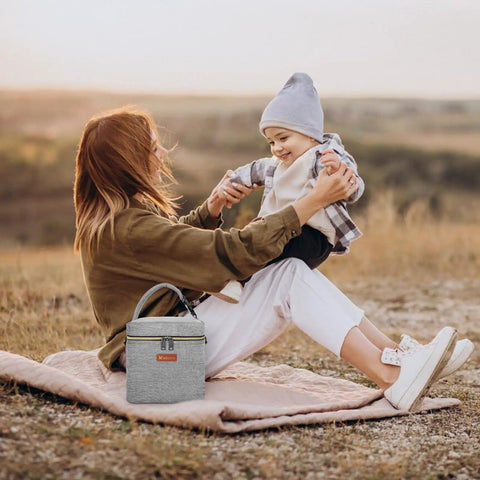 Mom with child outdoors, Grab And Go Insulated Breastmilk Cooler Bag Fits Four Nine Ounce Bottles Leakproof Travel Storage.