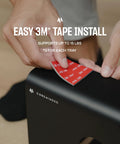 Applying adhesive to install Under Desk Cable Management Tray 2 Pack For MacBook Chargers And Power Strips Cord Organizer for standing desks.