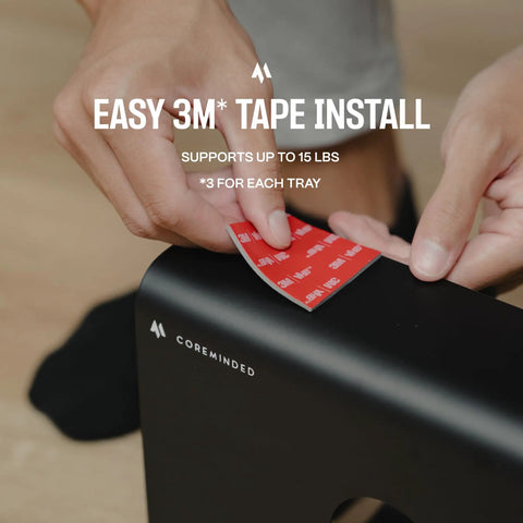 Applying adhesive to install Under Desk Cable Management Tray 2 Pack For MacBook Chargers And Power Strips Cord Organizer for standing desks.