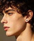 Profile view of a young man wearing Premium 5A Cubic Zirconia Screw Back Stud Earrings For Men And Women Hypoallergenic Surgical Steel.