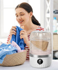 Woman using Compact Portable Washing Machine For Travelers And Students Slick Laundry Appliance in a bright room, feeling fresh laundry.