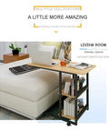 C Shaped Bedside Table With Heavy Duty Wheels And Locks Height Adjustable Laptop Workstation beside a sofa in a living room.
