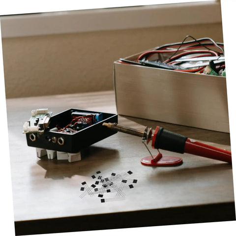Built Tough 20 Piece Hall Effect Sensor Kit With Bipolar Latching Linear Sensor For Heavy Duty Industrial Automation and Automotive Diagnostics Easy As Pie Dead Nuts Precise Magnetic Switches on a workbench with soldering iron.