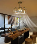 Caged Ceiling Fan with Light Wireless Control Gold Iron for Bedroom hanging above a wooden dining table in a modern room.
