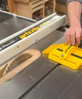 Adjustable Magnetic Featherboard For Table Saws And Router Tables Locks Stock Dead Tight Against Fence with hands positioning workpiece.
