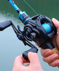 Person holding Digital Anti Backlash Baitcasting Reel No Fuss Casting With Smart Braking System Seven Point Two To One Gear Ratio