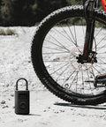 Portable Electric Air Compressor 2 With 150 Psi, Fast Inflate For Cars, Trucks And Bikes shown next to a bicycle tire.