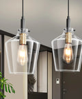 Modern Black And Gold Glass Pendant Light 2 Pack With Adjustable Height Cord For Kitchen Island Clear Round Shade E26 Socket hanging above a kitchen.