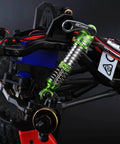 Close-up of green Lengthened Fifty Nine Millimeter Aluminum Oil Filled RC Shock Absorber Upgrade installed on an RC car.