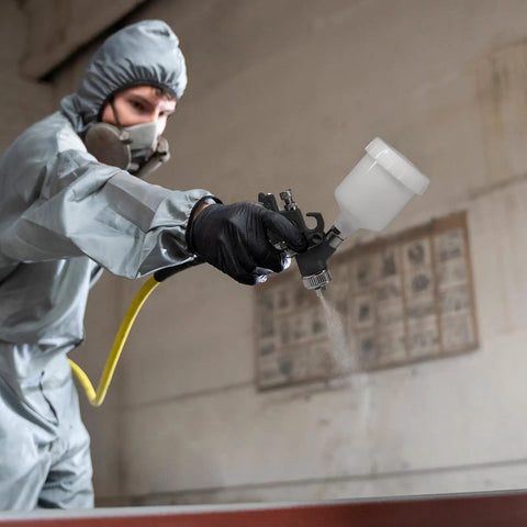 Mini HVLP Spray Gun With Precision Nozzles For Auto Touch Up Painting And Detailing in use by a masked individual.