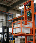 Heavy Duty Electric Freight Workhorse Featuring Quiet Hydraulic Wall Mounted Vertical Hoist lifting pallets in warehouse.