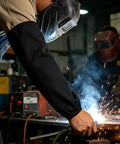 Heavy Duty Fireproof Welding Sleeves Heat Resistant Arm Guards Tough As Nails protecting arms while welding sparks fly.