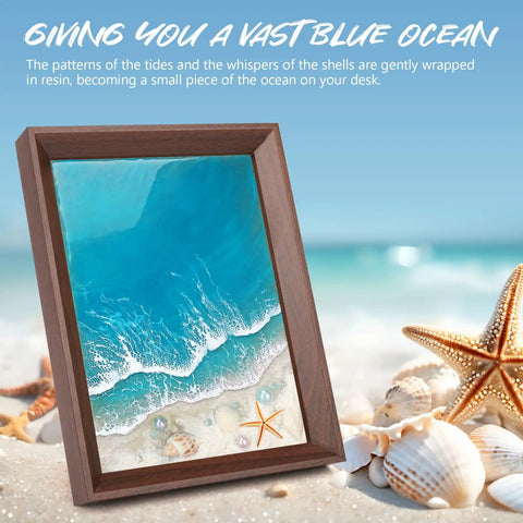 Ocean Resin Art Kit All In One For Beginners With Frames And Tools Epoxy Resin Set Includes UV Resin UV Light Pigments Sand Shells And Pearls Great Gift For DIY Lovers Stress Relief Creative Home Craft displayed in a wood frame with ocean scene and shells on a sandy beach background, emphasizing the DIY creative aspect.