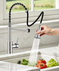 Kitchen Faucets with Pull Down Sprayer, Brushed Nickel in action, rinsing tomatoes and lettuce in a kitchen sink.