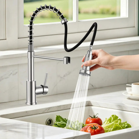 Kitchen Faucets with Pull Down Sprayer, Brushed Nickel in action, rinsing tomatoes and lettuce in a kitchen sink.