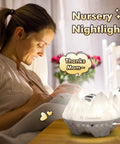Mother with baby, using 4 In 1 Northern Lights Aurora Projector With Bluetooth Speaker And White Noise Machine for nursery decor.