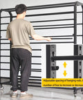 Man adjusting the adjustable rods on Heavy Duty Metal Vinyl Storage Cart With 18 Adjustable Rods And Smooth Rolling Lockable Casters For Tint Film Craft Wraps Wallpaper Rolls To Keep Your Shop Legit And Clean.