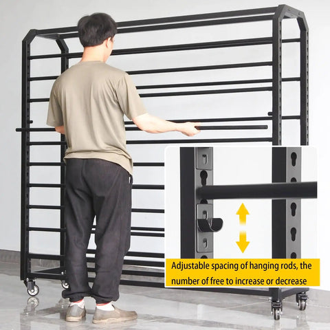 Man adjusting the adjustable rods on Heavy Duty Metal Vinyl Storage Cart With 18 Adjustable Rods And Smooth Rolling Lockable Casters For Tint Film Craft Wraps Wallpaper Rolls To Keep Your Shop Legit And Clean.