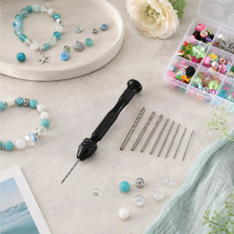 Badass Mini Micro Drill Bit Set With Tough Pin Vise And Slick Carburetor Jet Plus Jeweler Twist Bits From Point Five To Three Millimeters laid out with jewelry and beads.