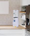 Penguin Style Mini Water Dispenser 2.5 Liter Personal Water Cooler Holds 8 Glasses No Plug Room Temperature displayed on kitchen counter
