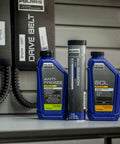 All Season Grease For Snowmobiles And Off Road Rigs Water Resistant Lubricant bottle displayed on shelf next to antifreeze and oil