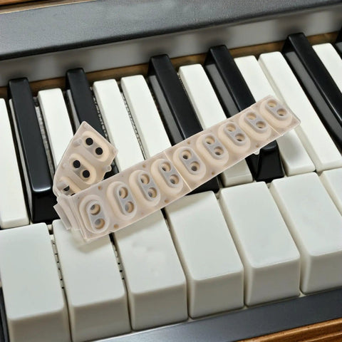 DIY Friendly Silicone Key Contact Strip For 13 Key Digital Pianos And Electronic Keyboards Replacement resting on keys