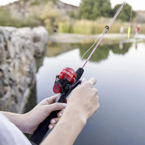 Dock Demon Spincast Reel And Fishing Rod Combo 30 Inch Fiberglass Rod With EVA Handle used by a dockside angler, red design