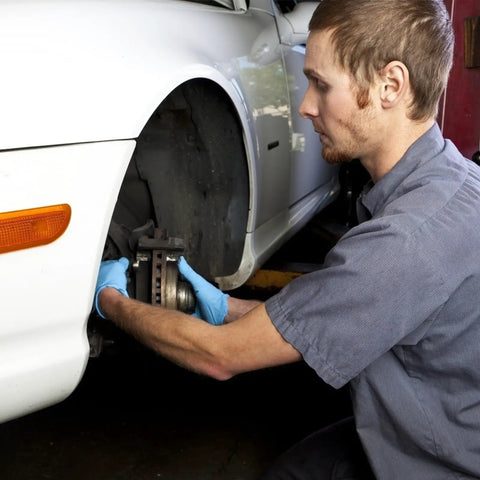 Mechanic working on car brake with internal tooth lock washers and push on fastening clips kit, 340 piece assortment setup.