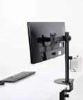 Heavy Duty Steel Reinforcement Bracket And Mount Plate For Glass Or Thin Desks with C Clamp Monitor Arm on a desk.