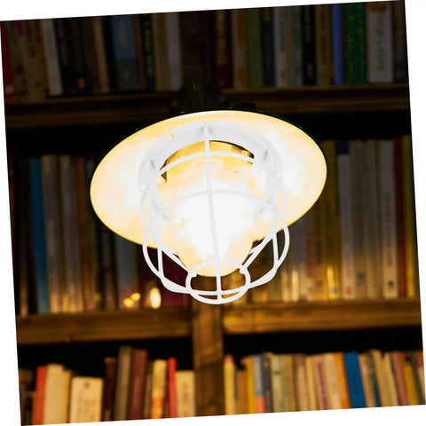 Heavy Duty Wire Lamp Shade And Bulb Guard Cage, white protective fixture over warm bulb in library setting.