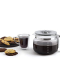Boost Your Daily Grind With This Smooth Operator Retro Drip Coffee Maker Featuring 10 Cup Glass Carafe with brewed coffee and cookies.