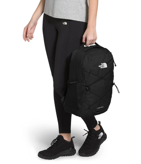 Woman standing holding Jester Women Laptop Backpack With Padded Sleeve For Commuters And Travelers Water Repellent Everyday Carry.