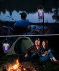 Camping scene with All In One Solar And USB C Rechargeable Bug Zapper With LED Light 2 In 1 Mosquito Killer near tent and campfire.