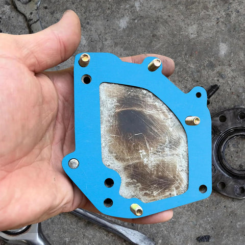 6-piece blue 8x8 inch non-asbestos gasket sheets with bolt holes and metal center insert, held in hand.
