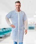 Adult model wearing 10 Pack White Disposable Lab Coats For Adults 3X Large With Elastic Wrists And Loop Closures Knee Length 35 GSM Polypropylene