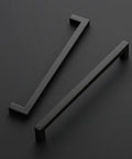 Two matte black cabinet handles from the 32 Pack Matte Black Cabinet Handles 8-4/5 Inch Square Pulls For Drawers And Kitchen Cabinets Hardware Set For Cupboards Durable Modern Hardware Heavy Duty Build, shown on a dark background.