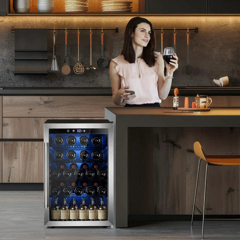 Woman enjoying wine next to 37 Bottle Freestanding Wine Cooler With Stainless Steel Reversible Glass Door And Quiet Compressor For Home Kitchen Bar Four Point Five Cubic Feet Silver Beverage Refrigerator in modern kitchen setting.
