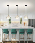 Yuniexuber 2 Pack Modern Mid Century Globe Pendant Lights in brass gold and black over a kitchen island with white glass shades.