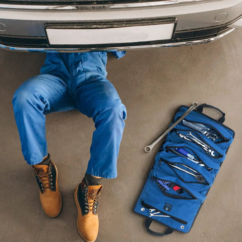 Mechanic under car with Heavy Duty Tool Roll For Pros With Ultra Durable Water Resistant And Grease Resistant Fabric Reinforced Seams