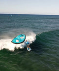 Surfer using Alien Wing 6M High Performance Wind Wing For Foiling And Surfing Lightweight Aerodynamic Rigid Wing Includes Backpack Wrist Leash And Repair Kit Tri Color on ocean wave.