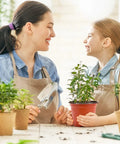 Mother and daughter smiling over 100 Pack 6 Inch Plant Nursery Pots Reusable Waterproof Plastic Pots Seed Starting Pots