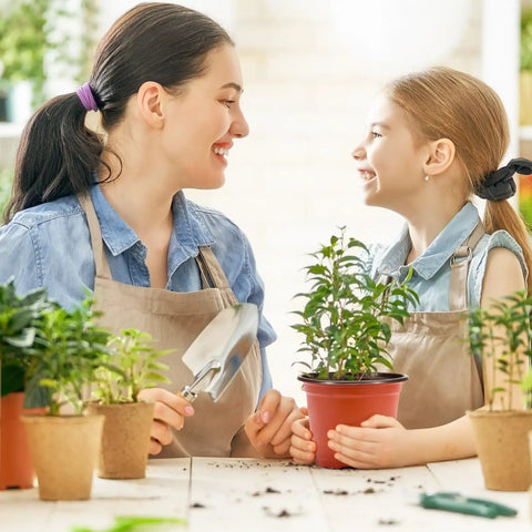 Mother and daughter smiling over 100 Pack 6 Inch Plant Nursery Pots Reusable Waterproof Plastic Pots Seed Starting Pots
