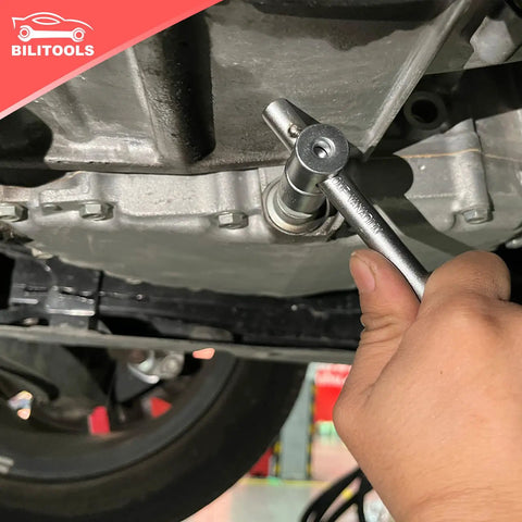 Hand using tool from 23 Piece Drain Plug Socket Set For Oil Sump And Gearbox, Three Eighth Inch Drive With Hex, Square, Spline, Torx.