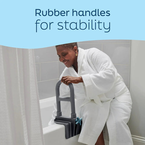 Woman using Deluxe Tub Grab Bar With Microban Protection on bath edge for support, gray enamel-coated steel, ADA compliant.
