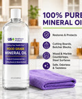 32oz Food Grade Mineral Oil For Cutting Boards And Wood Surfaces No Fuss Restores Protects And Seals Butcher Blocks Countertops And Steel Surfaces Keeps Wood Smooth Safe And Rust Free USP Verified bottle on kitchen counter next to purple cloth.